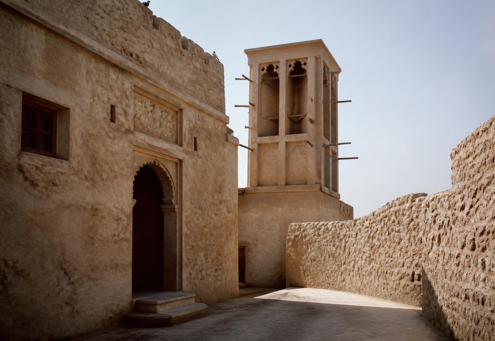 Historic coral-stone architecture and wind tower in Ajman